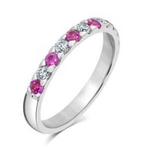 Round cut pink sapphire and diamond half eternity ring