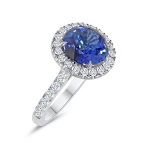 Round cut sapphire and diamond cluster ring with diamond shoulders